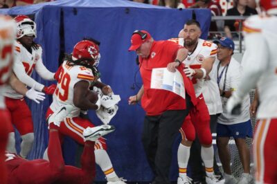 Travis saving Coach Reid from getting hit
